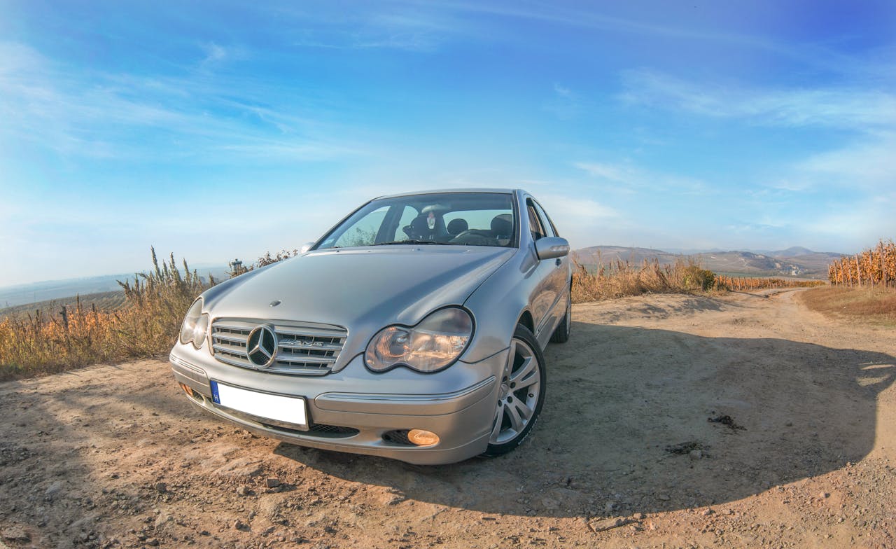 Gray Car Parked on Dirt Road